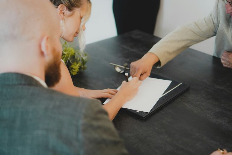 Notary pointing out where to sign on the loan document.