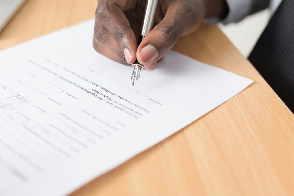 A gentleman signing a business document.